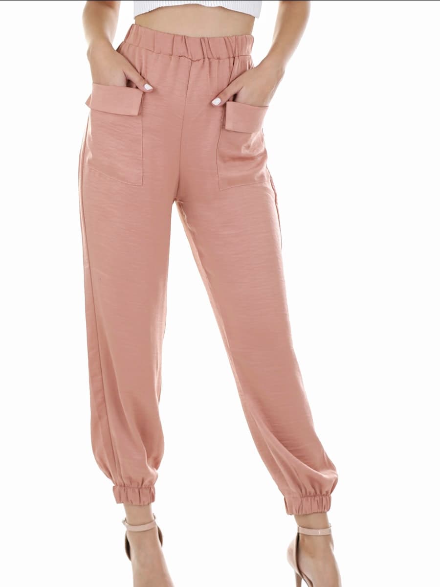 Model wearing blush paperbag-waist tapered trousers