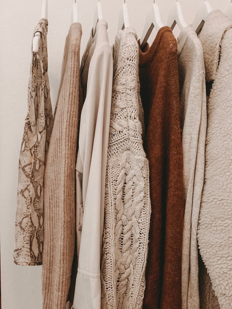 A rail of neutral-toned winter knitwear
