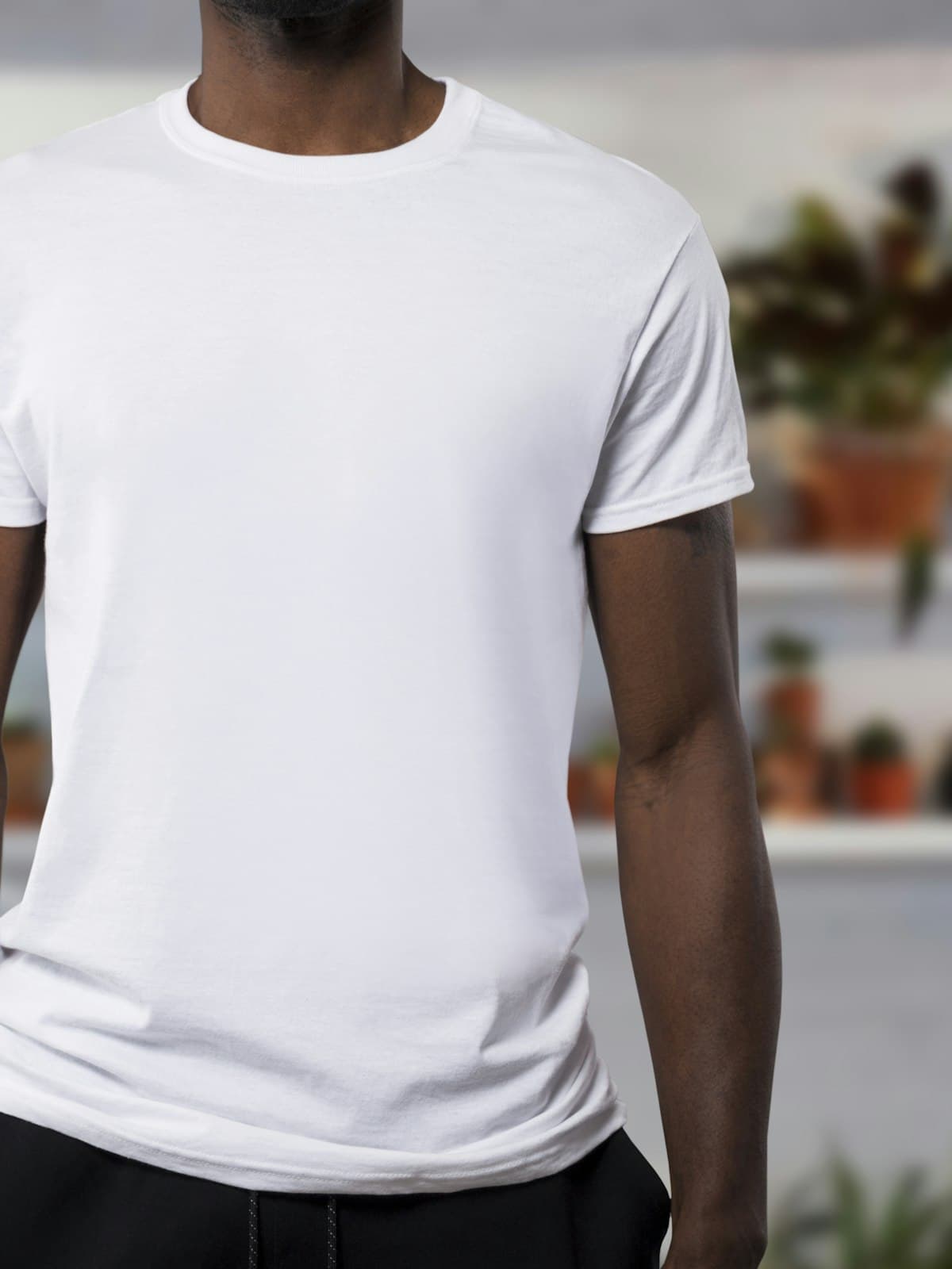 Model wearing a plain white crew neck cotton tee