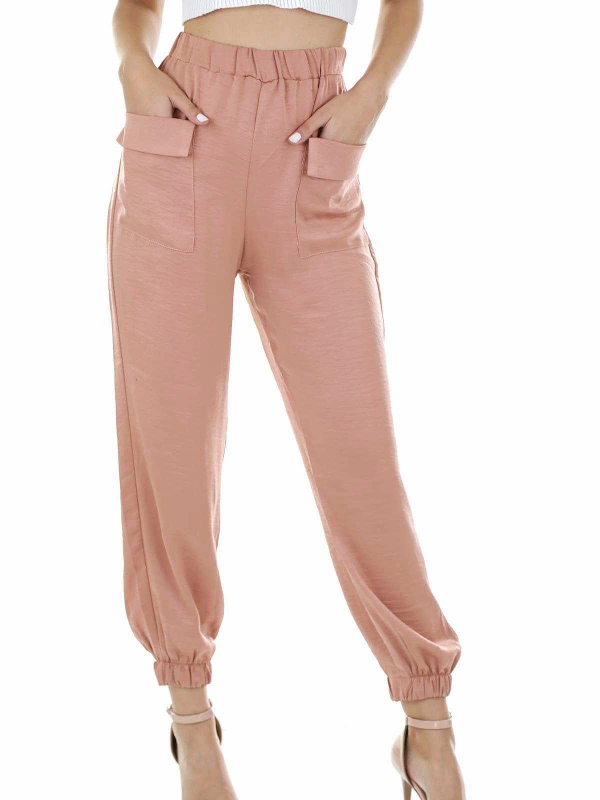 Model wearing blush paperbag-waist tapered trousers with heeled sandals