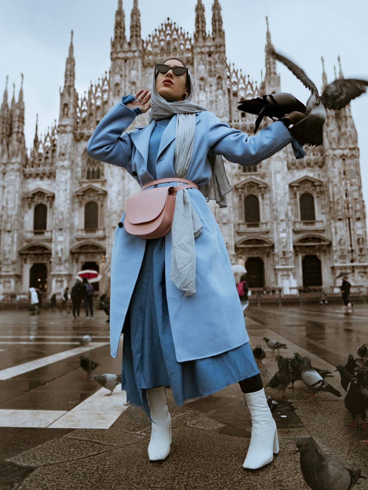 Model wearing the powder blue belted trench coat in a European city square