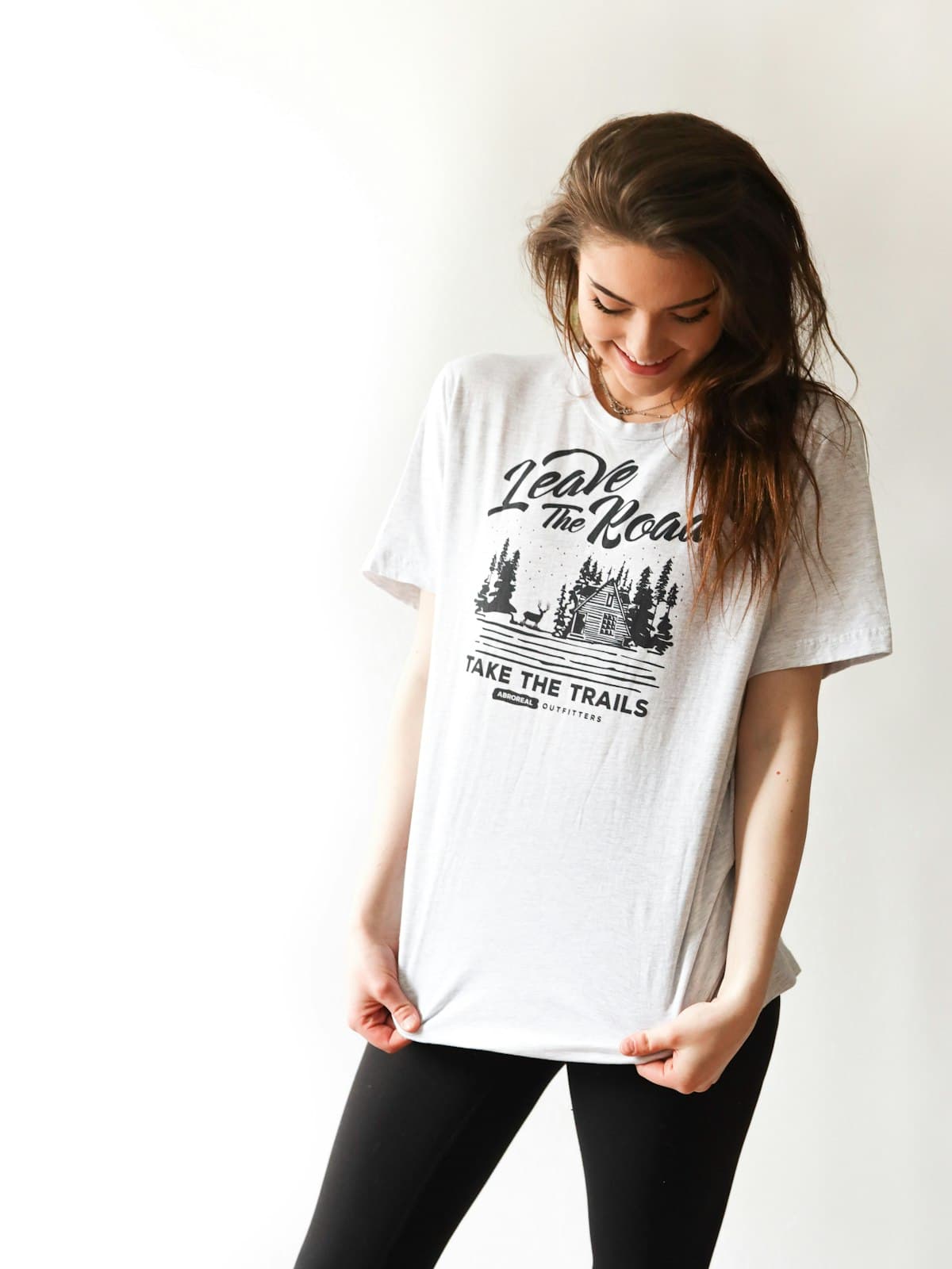Model wearing the Trail print white cotton tee with black leggings