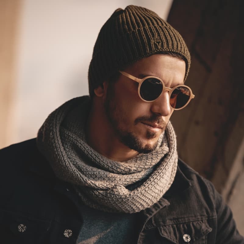 Model wearing a ribbed grey infinity scarf and beanie