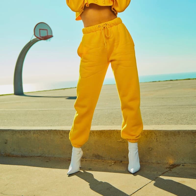 Model in a yellow cropped hoodie and matching joggers