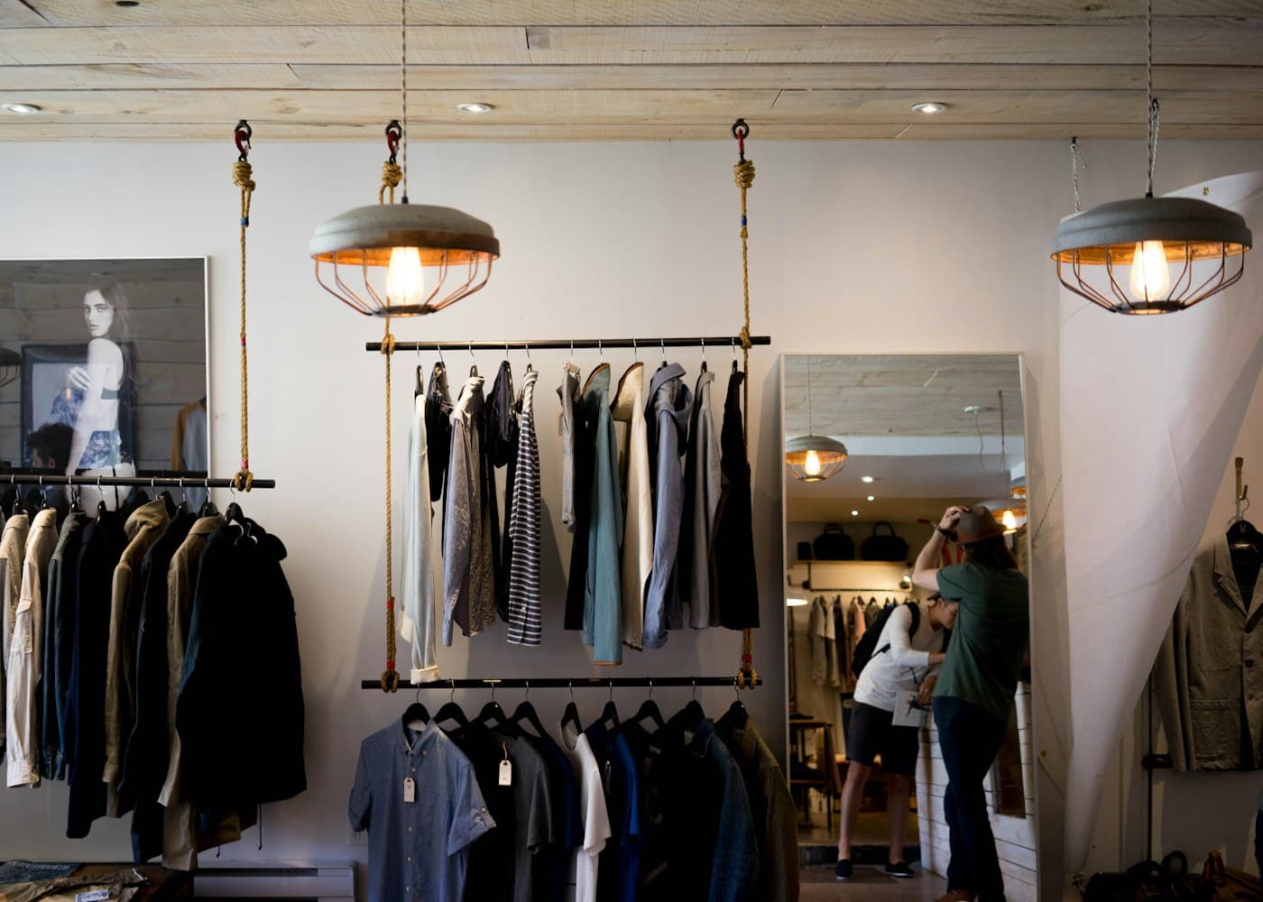 The interior of a light-filled clothing boutique with rails of garments